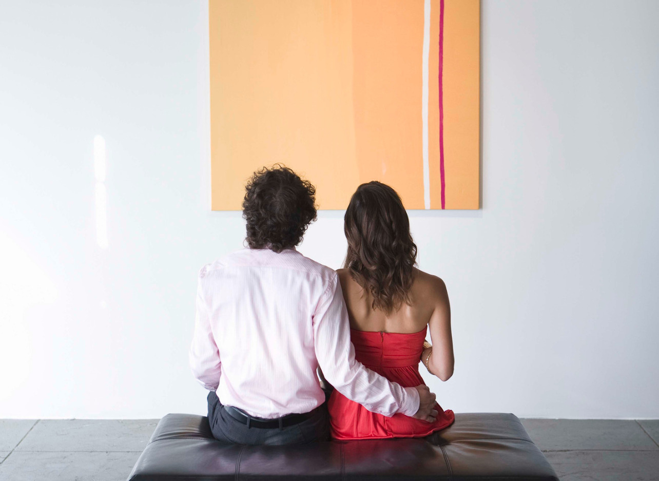 couple looking at art on wall
